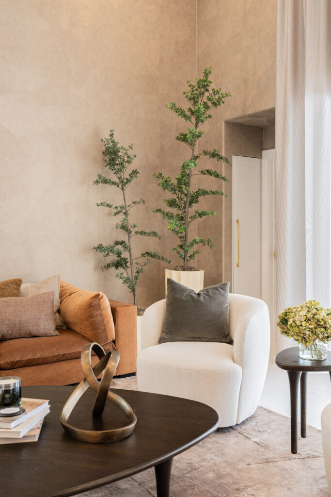 a living room with a couch and a plant